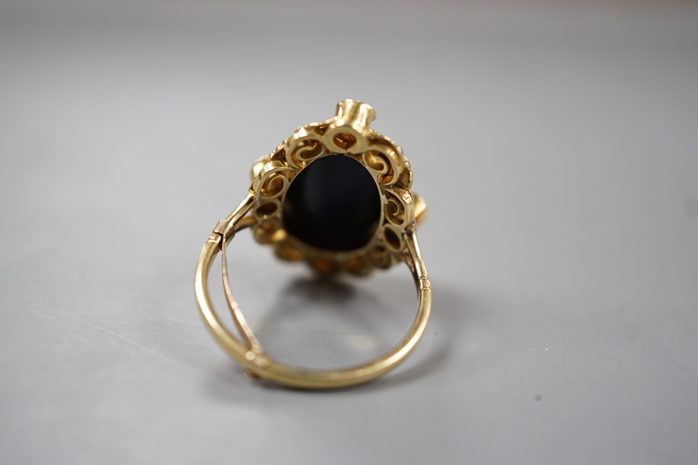 An 18ct Arts & Crafts style oval black doublet and split pearl cluster set dress ring, size Q, gross weight 5.9 grams.